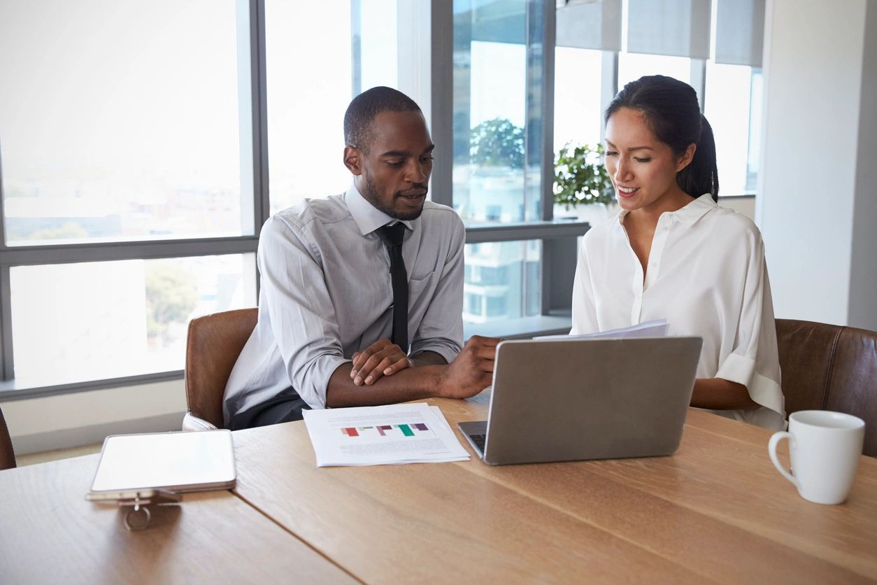 A man and woman working on digital marketing.