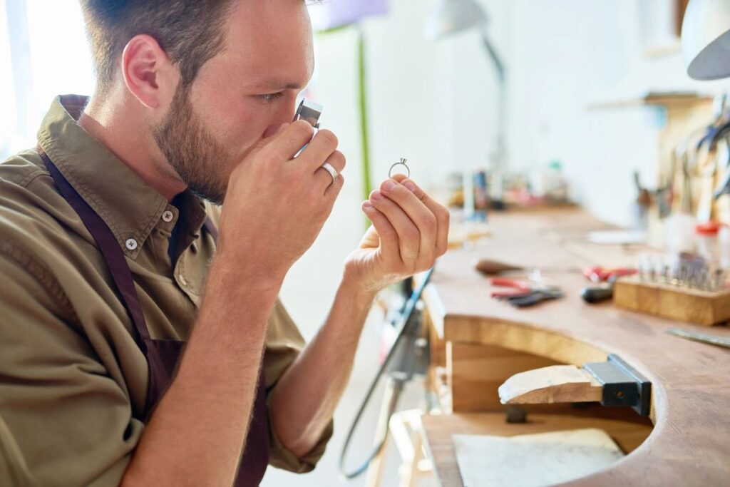 A man making jewellery. Our jewellery SEO guide will explain how to boost traffic to your website.