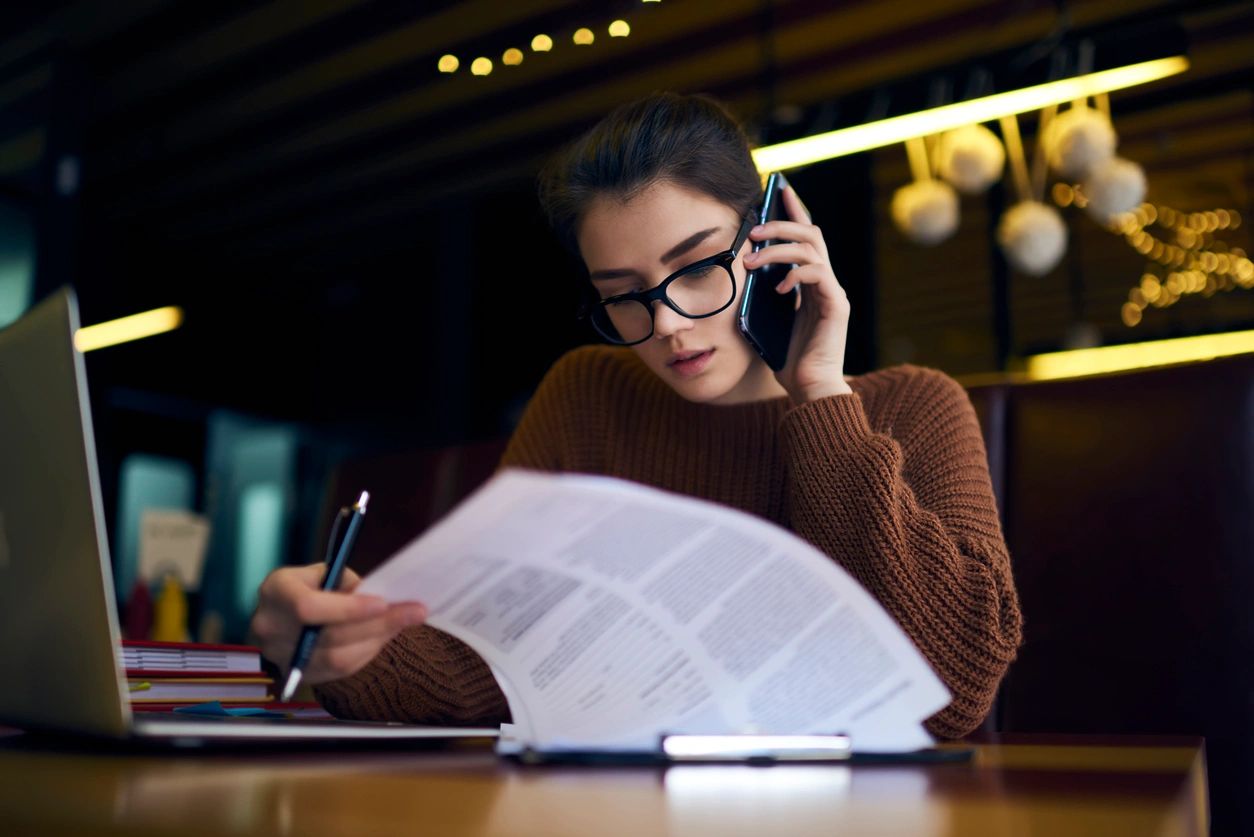 A woman reading a report about various industries.