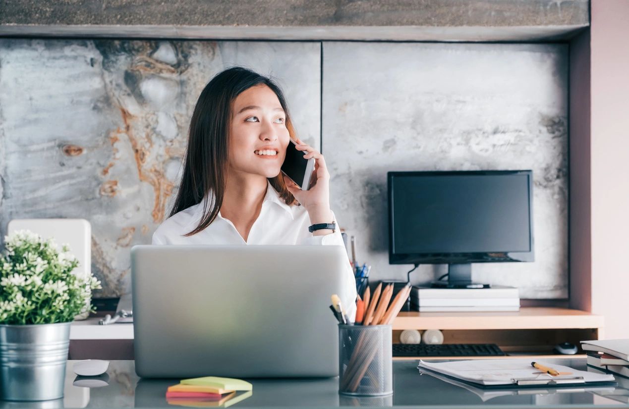 A woman speaking on the phone and developing ways to grow her small business.