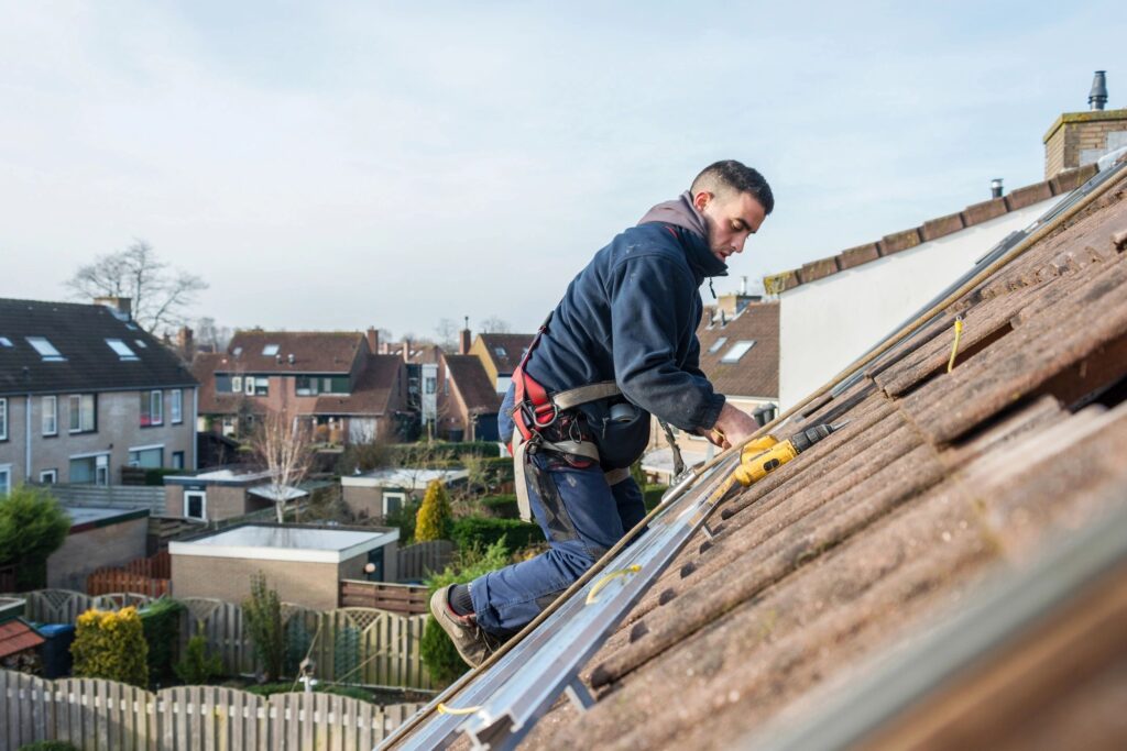 A man fixing a roof. Websites drive more traffic to roofing companies.