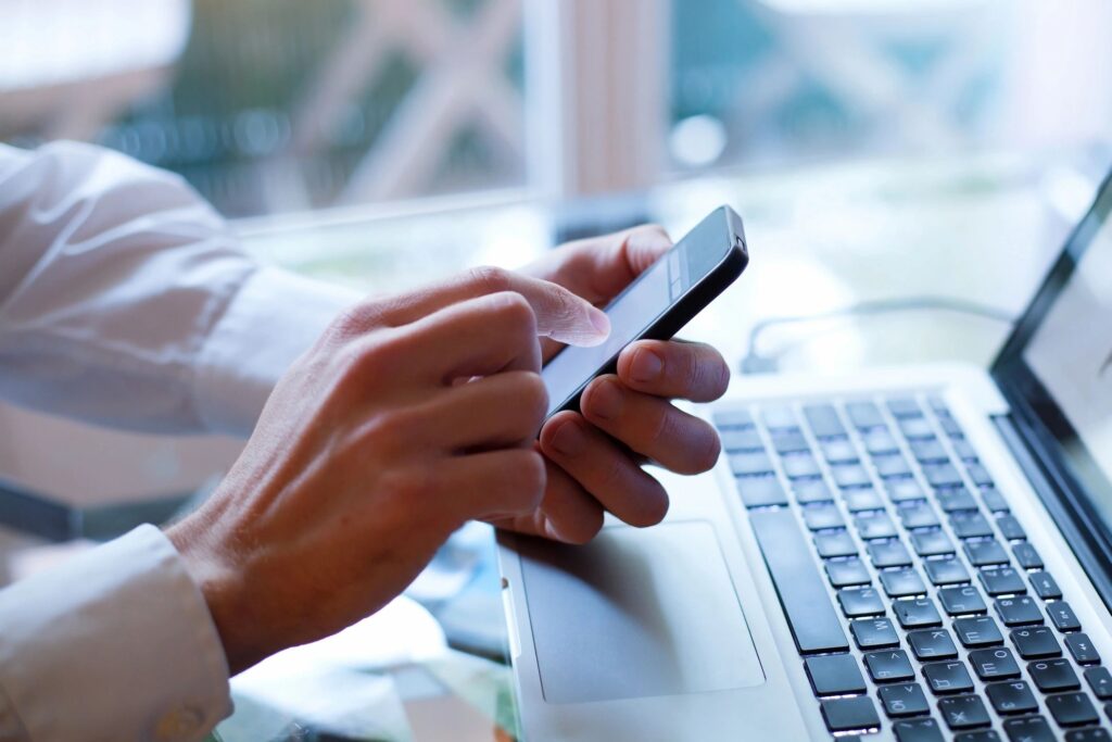 A man looking at a Google Business Profile on his smartphone.